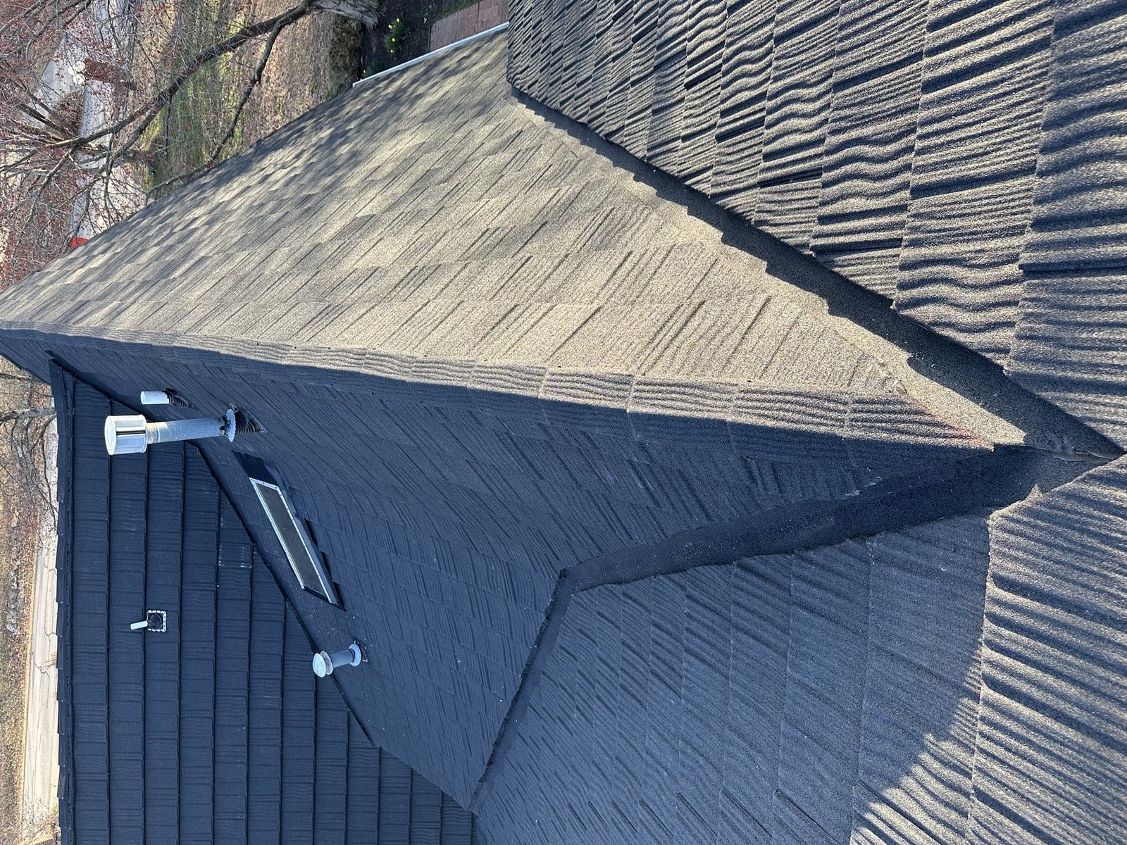 Completed architectural shingle hip roof with new ridge cap